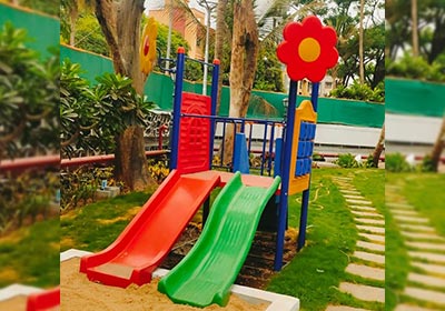 Combination of 3 slides, rock climber, double swing and family swing for kids